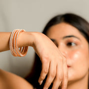 Enchanting Rose Gold Plated Double Row Crystal Stone Studded Bangles Set (Pack of 4)