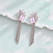 Rhodium Plated Crystal Fringe Earrings with Floral Sunburst Design and Square Stone Embellishments