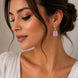 Rhodium Plated Emerald Cut Halo Drop Earrings with Sparkling Stone Accent