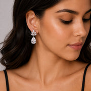 Rhodium Plated Pear Drop Earrings with Floral Stone Design