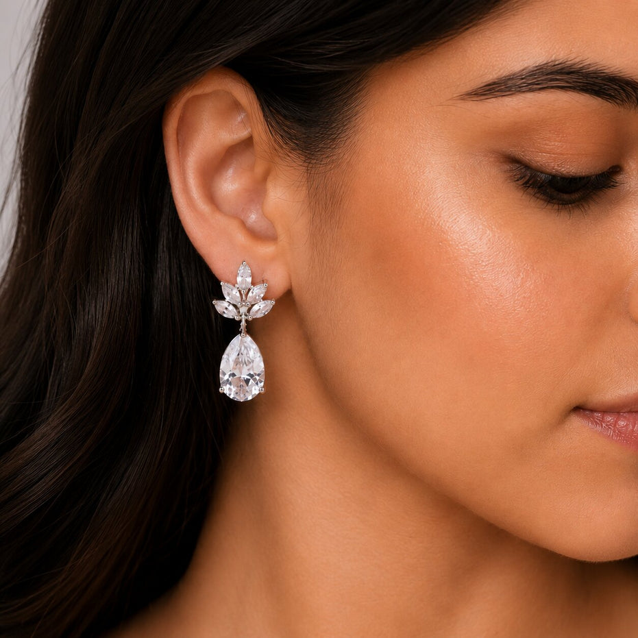 Rhodium Plated Pear Drop Earrings with Floral Stone Design