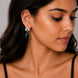 Rhodium Plated Pear Drop Earrings with Floral Stone Design