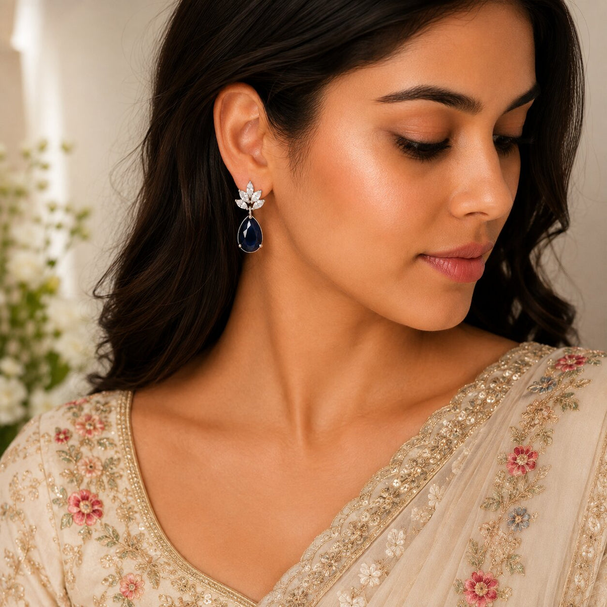 Rhodium Plated Pear Drop Earrings with Floral Stone Design