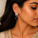 Rhodium Plated Pear Drop Earrings with Floral Stone Design