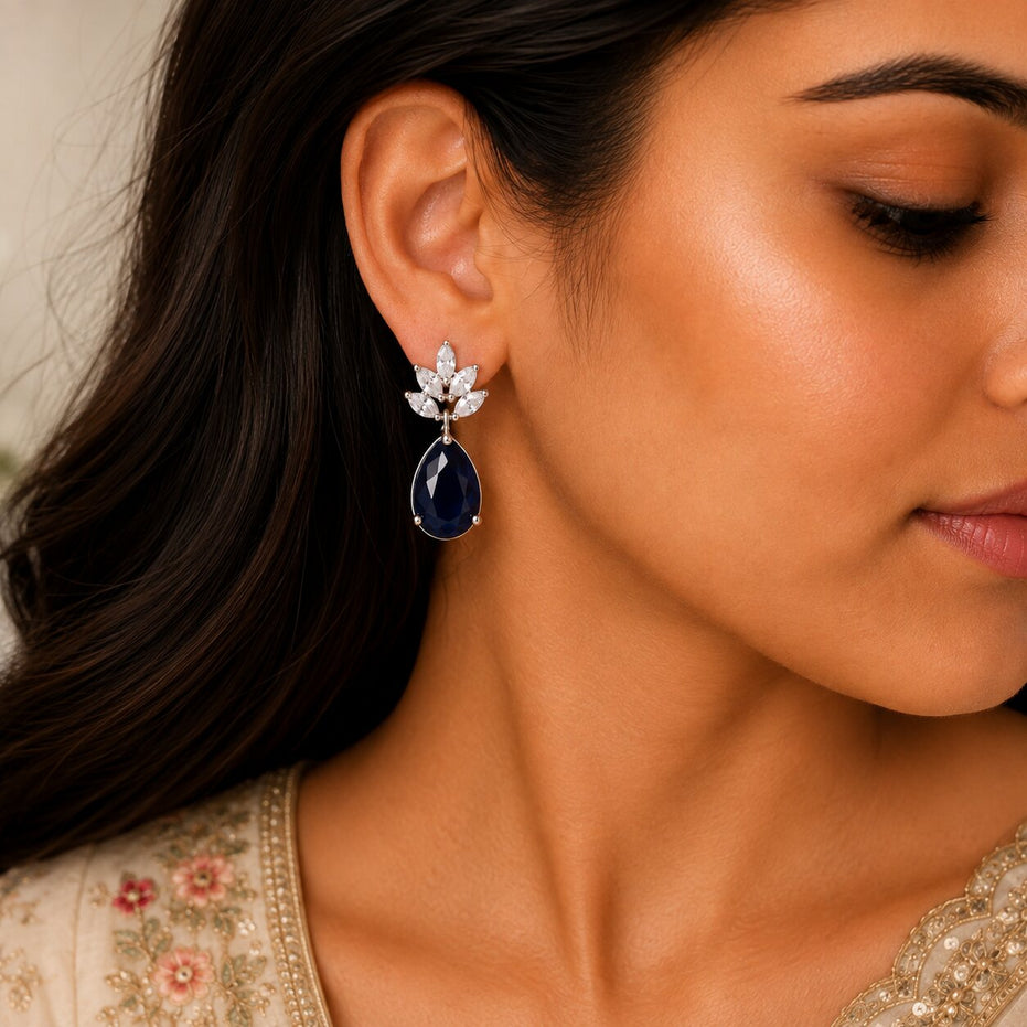 Rhodium Plated Pear Drop Earrings with Floral Stone Design