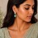 Rhodium Plated Pear Drop Earrings with Floral Stone Design