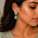 Rhodium Plated Pear Drop Earrings with Floral Stone Design