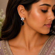 Rhodium Plated Pear Drop Earrings with Floral Stone Design