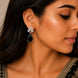 Rhodium Plated Pear Drop Earrings with Floral Stone Design