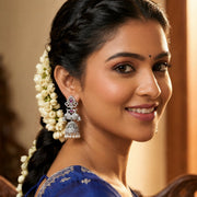 Rhodium Plated Floral Motifs & Intricate Traditional Stone Work Pearl Drops Jhumka Earrings
