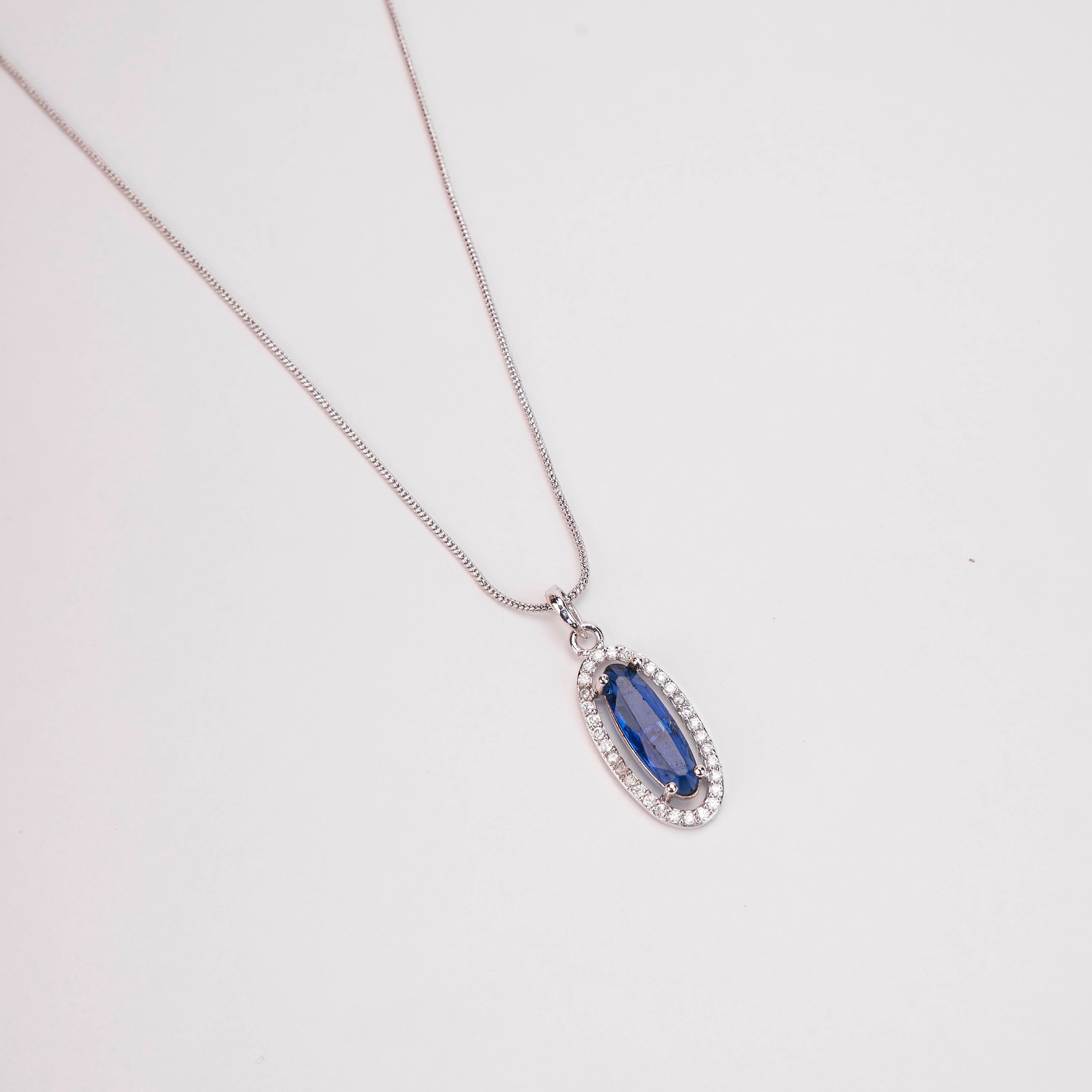 Elongated Oval Halo Design Rhodium Plated Pendant with chain-Crystal Blue