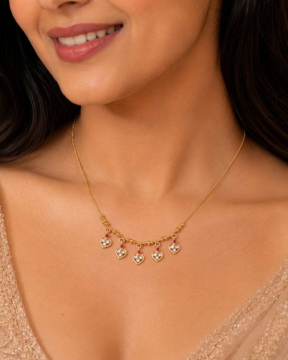 Gold Plated American Diamond Heart Charm Necklace with Stone Studded Dangle Charms